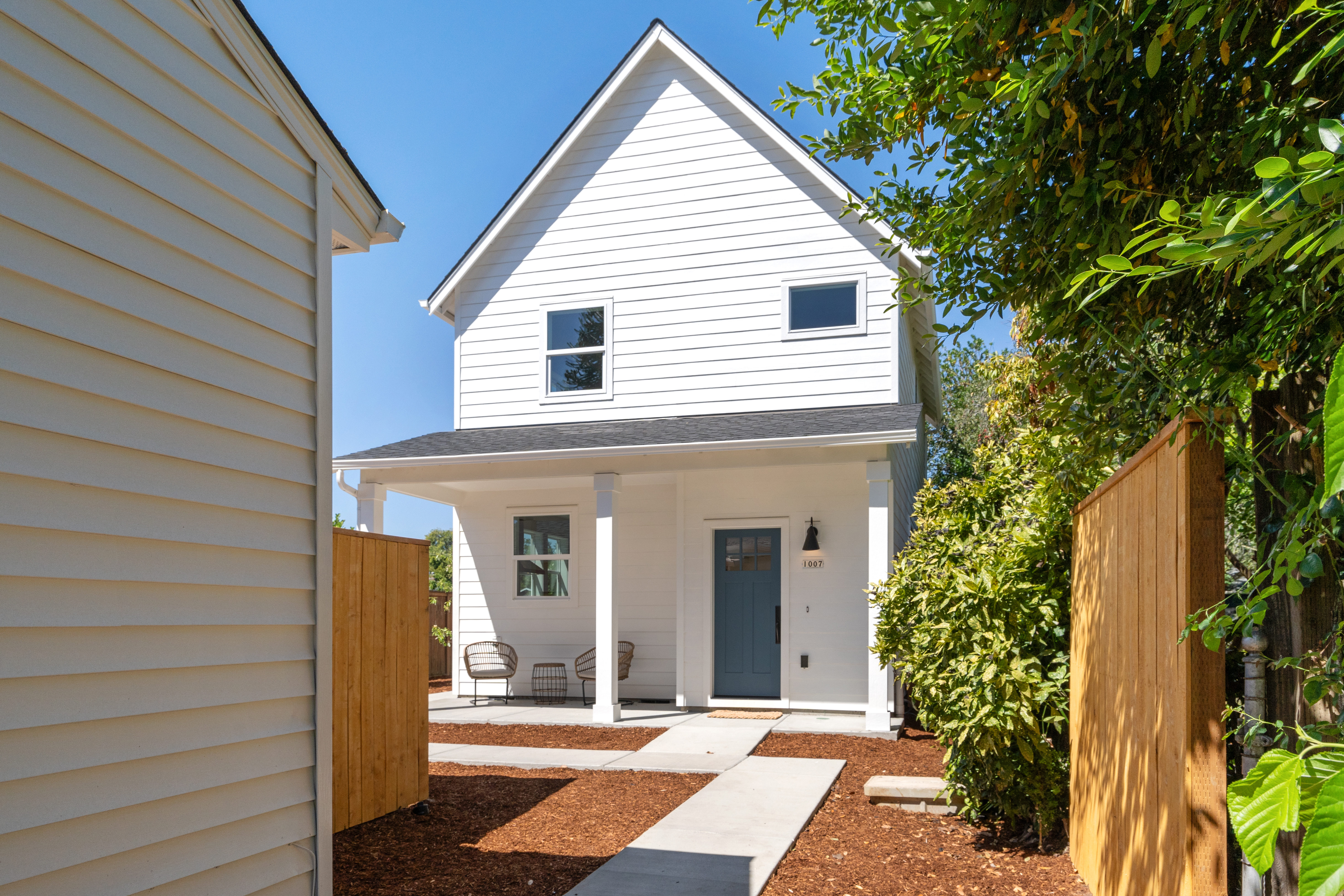 Cottage exterior with blue door and covered porch