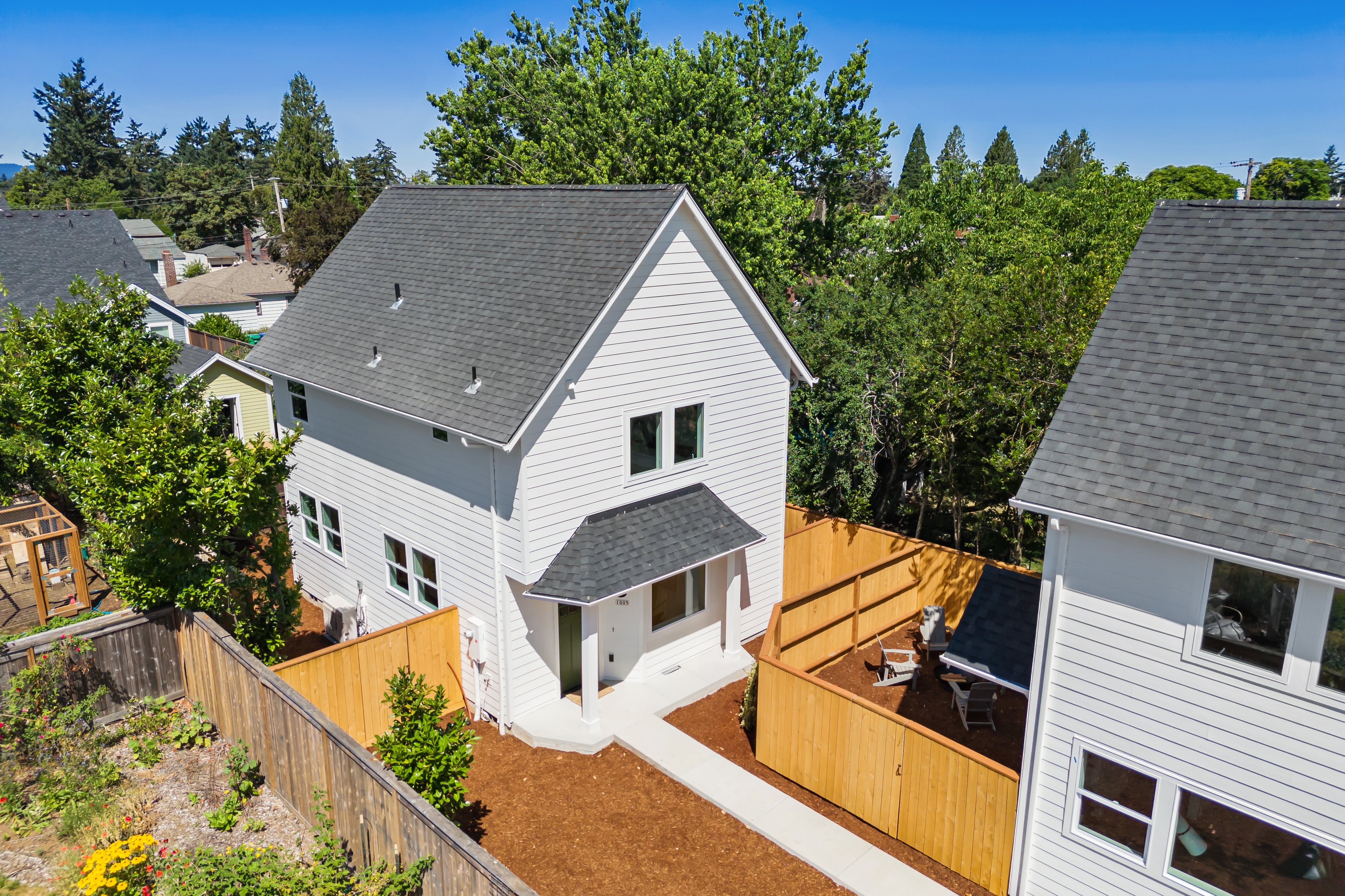 Aerial view showing backyard and neighborhood context