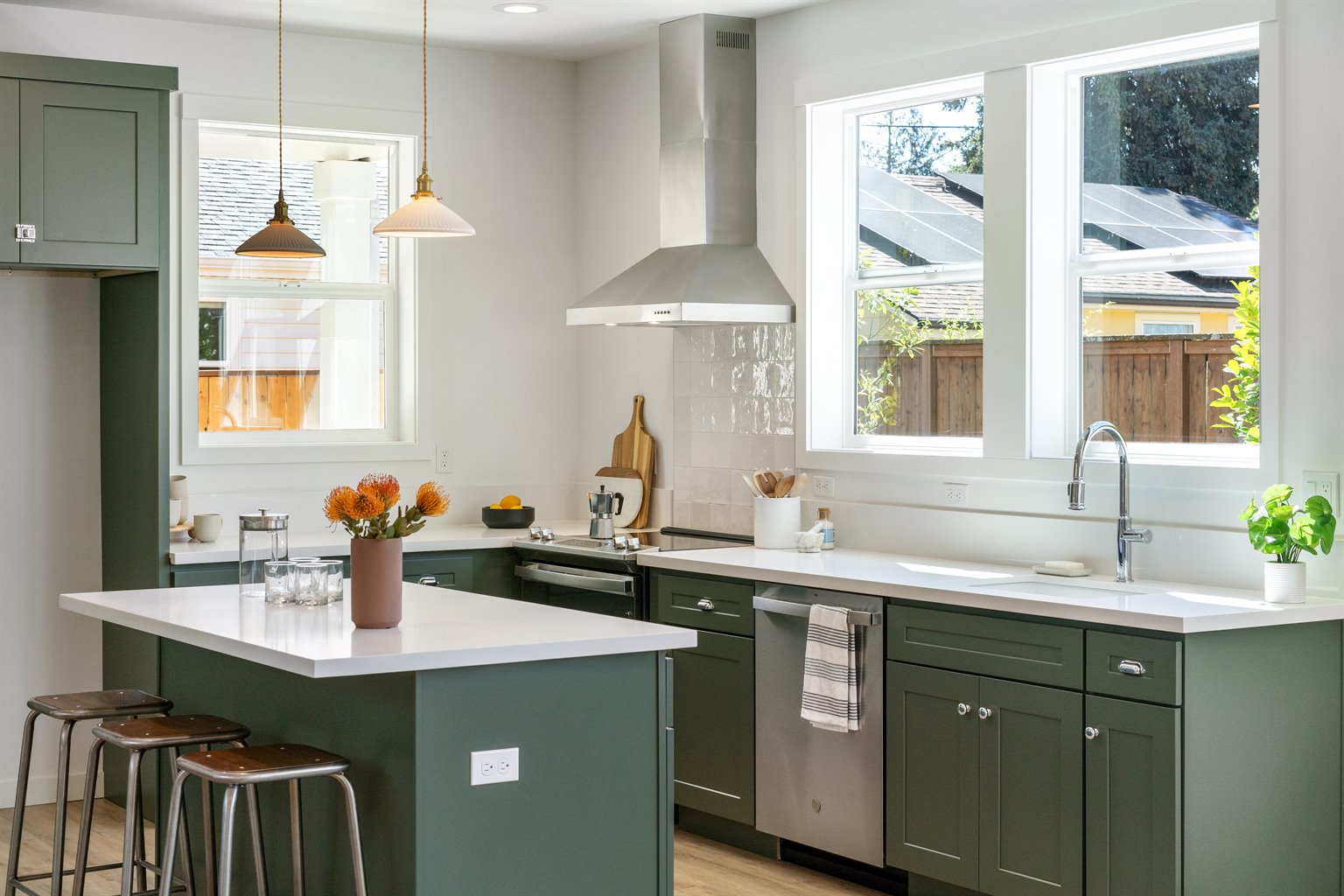 Kitchen with green cabinets and island