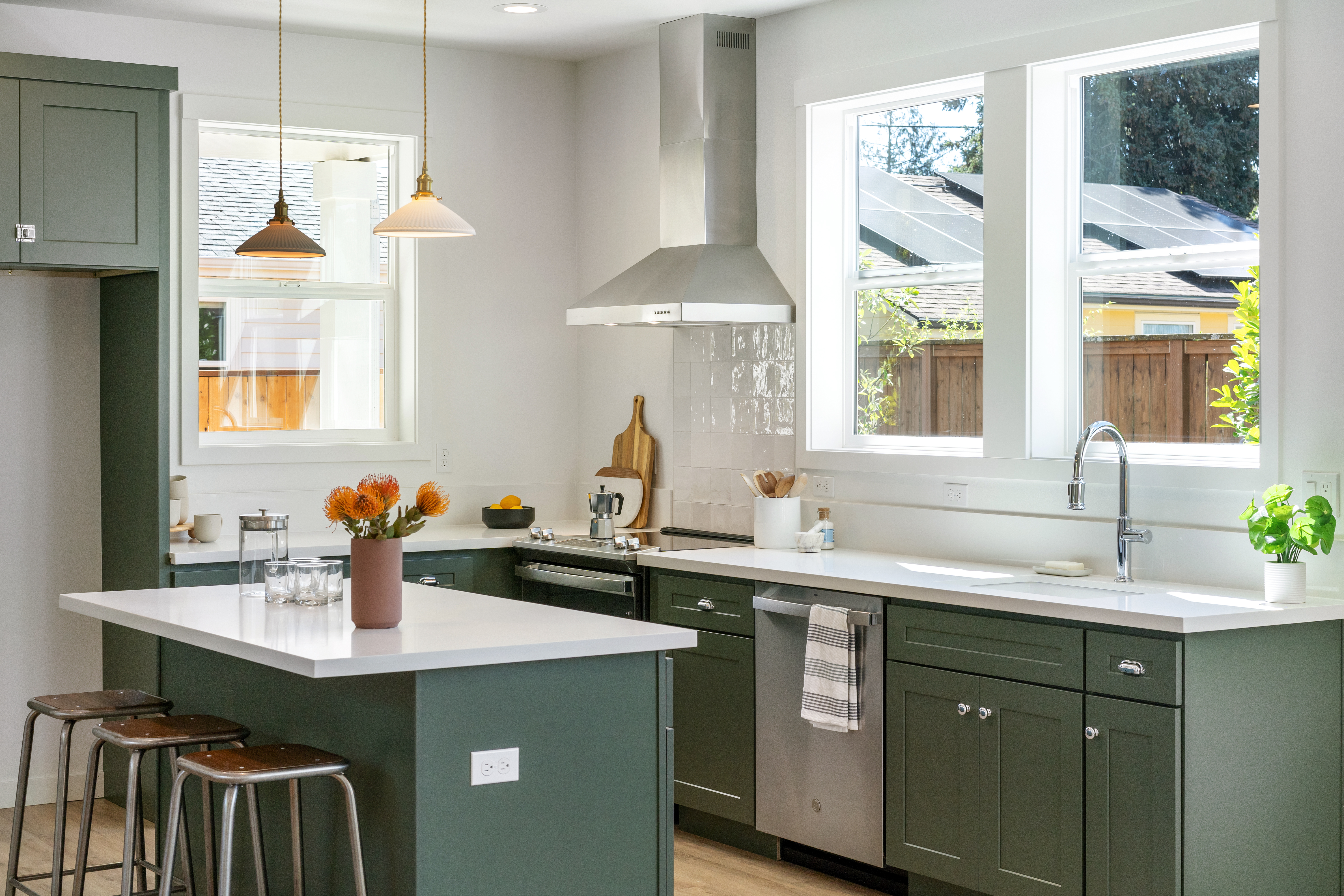 Kitchen with green cabinets and island