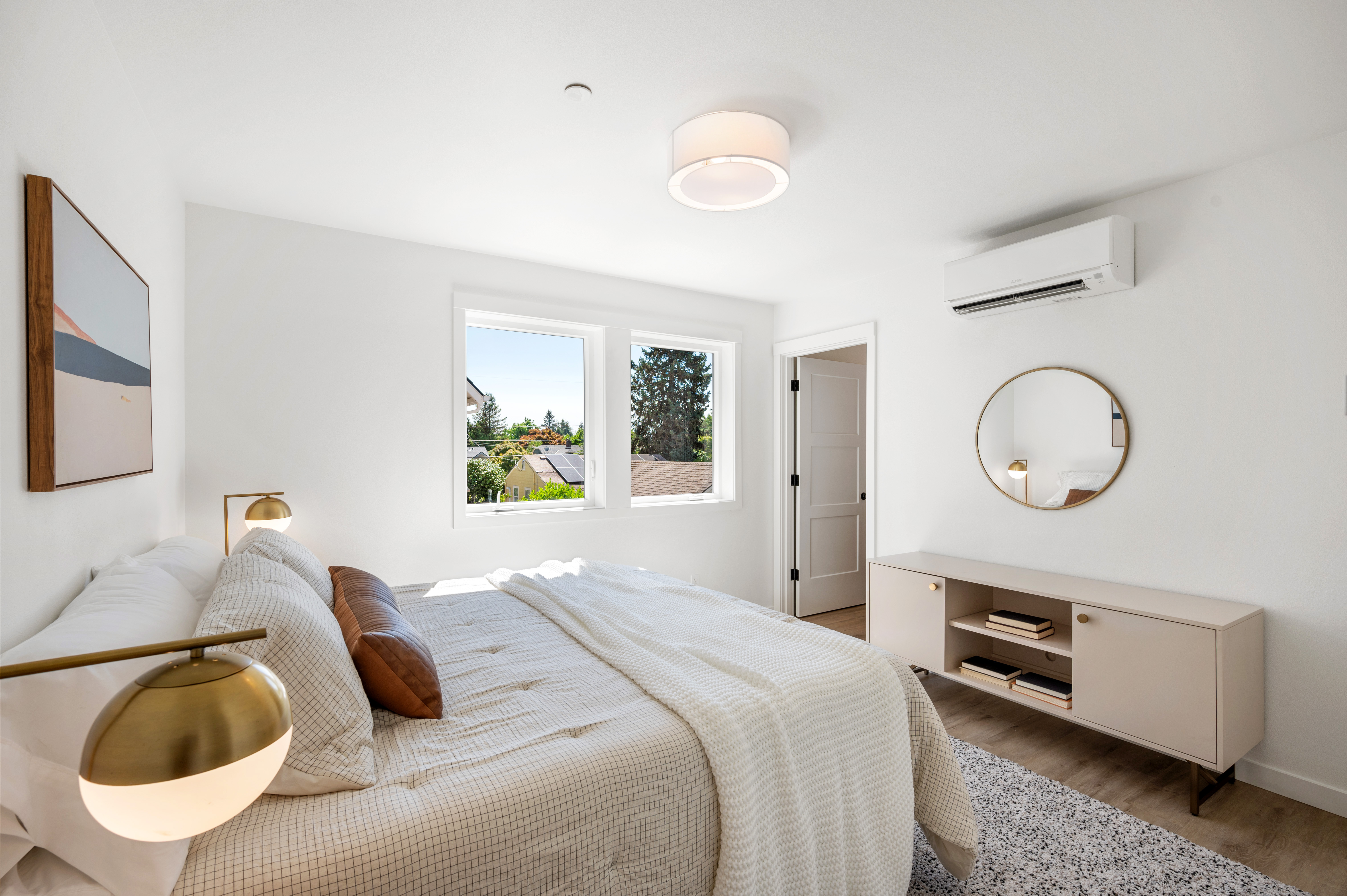 Bedroom with mini-split and gold fixtures