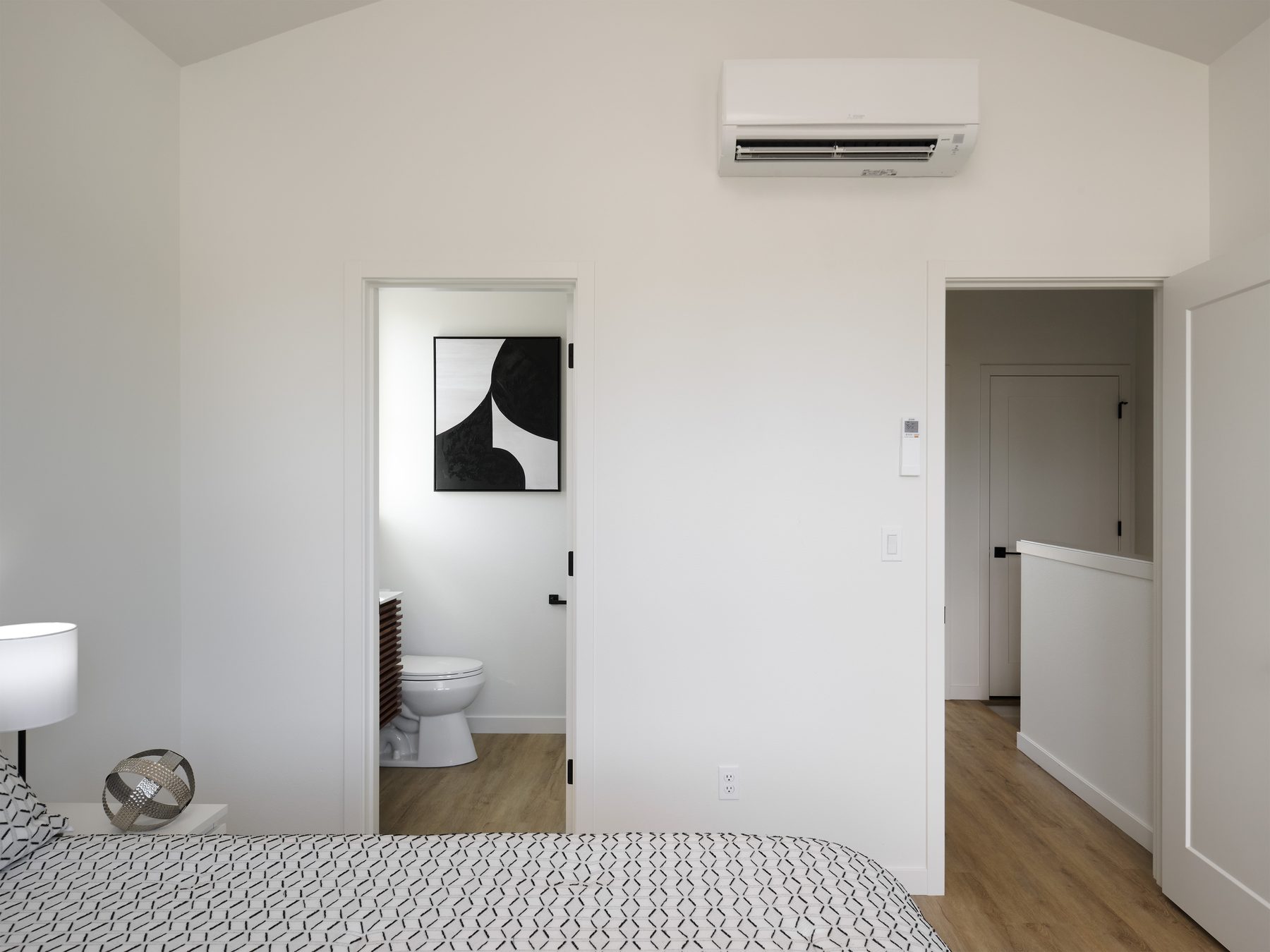 Bedroom with vaulted ceiling, ductless mini-split, and ensuite bath
